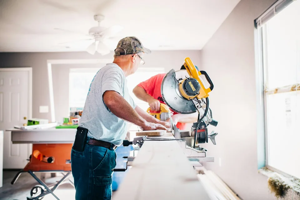 Carpenter cutting timber for interior work