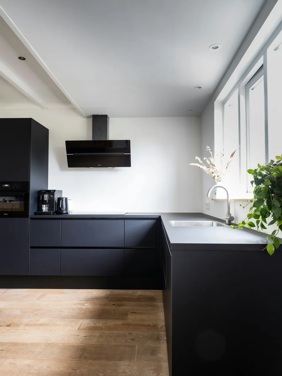 Dark fitted kitchen with a clear floor area