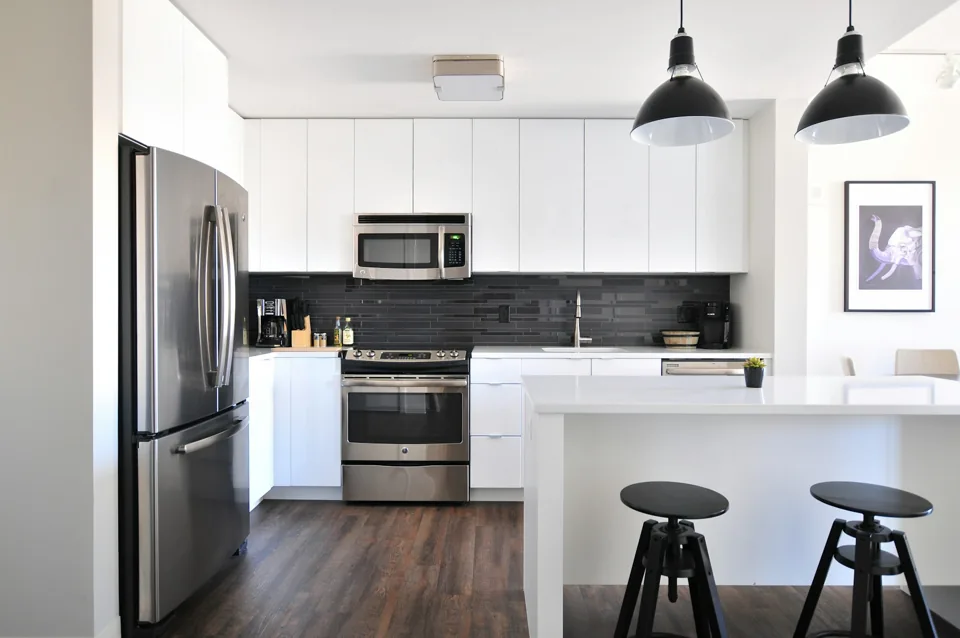 White fitted kitchen with a breakfast counter